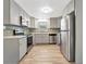Modern kitchen with stainless steel appliances, grey cabinetry and light wood flooring at 1135 17Th Sw Ave, Largo, FL 33778