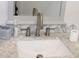 Bathroom sink and marble counter top with modern fixtures and a decorative mirror at 12794 Palm Dr, Largo, FL 33774