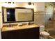 Bathroom featuring double sinks, granite counters and tiled walk-in shower at 12794 Palm Dr, Largo, FL 33774