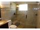Bathroom featuring tiled walk-in shower with glass door and seating at 12794 Palm Dr, Largo, FL 33774