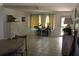 Bright dining room with tile floors, white walls, dresser and bicycle accent, enhancing the home's charm at 12794 Palm Dr, Largo, FL 33774