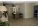 Open dining area with tile floors, modern lighting, and neutral tones providing versatile living space at 12794 Palm Dr, Largo, FL 33774