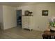 Inviting dining area featuring tile floors, white walls, and a glimpse into a cozy bedroom at 12794 Palm Dr, Largo, FL 33774