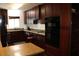 Stylish kitchen with dark wood cabinetry, granite countertops, and high-end appliances for gourmet cooking at 12794 Palm Dr, Largo, FL 33774