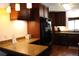 Modern kitchen featuring wood cabinets, granite countertops, and stainless steel appliances at 12794 Palm Dr, Largo, FL 33774