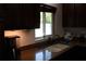 Kitchen with brown cabinetry, granite counters and stainless steel faucet at 12794 Palm Dr, Largo, FL 33774
