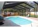 A stunning screened-in pool with inviting turquoise water and a cozy seating area, perfect for leisure at 12794 Palm Dr, Largo, FL 33774