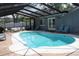A beautiful pool area featuring a sparkling pool, comfortable seating, and a serene outdoor space at 12794 Palm Dr, Largo, FL 33774