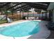 A pristine screened-in pool area with ample seating, perfect for relaxation and outdoor enjoyment at 12794 Palm Dr, Largo, FL 33774