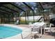 Relaxing pool and outdoor dining area, perfect for gatherings and enjoying the beautiful surroundings at 12794 Palm Dr, Largo, FL 33774