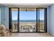 Ocean view balcony with sliding glass doors and seating for enjoying the outdoors at 1290 Gulf Blvd # 702, Clearwater Beach, FL 33767