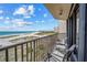 Balcony view overlooking a beautiful white sand beach, offering a serene retreat with comfortable seating and stunning coastal scenery at 1290 Gulf Blvd # 702, Clearwater Beach, FL 33767