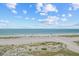 Serene beach view with clear blue ocean waters and a tranquil sky at 1290 Gulf Blvd # 702, Clearwater Beach, FL 33767