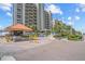 A gated entrance with palm trees and a guard house at 1290 Gulf Blvd # 702, Clearwater Beach, FL 33767