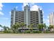 High-rise building featuring a clean facade, palm trees, and meticulously maintained landscaping, adding to the property's allure at 1290 Gulf Blvd # 702, Clearwater Beach, FL 33767