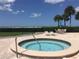 Inviting hot tub with beach views and patio furniture for relaxing and entertaining near swaying palm trees at 1290 Gulf Blvd # 702, Clearwater Beach, FL 33767