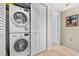 Convenient laundry room with stacked washer and dryer and extra storage at 1290 Gulf Blvd # 702, Clearwater Beach, FL 33767