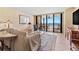 Comfortable living area with neutral tones, coastal views, and access to a large balcony, enhancing the living experience at 1290 Gulf Blvd # 702, Clearwater Beach, FL 33767