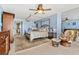 Spacious main bedroom with a canopy bed, comfortable chairs, and a large mirrored wall at 1290 Gulf Blvd # 702, Clearwater Beach, FL 33767