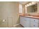 Well-lit bathroom with a window, a white vanity with a pink countertop and ample cabinet space at 14047 Briardale Ln, Tampa, FL 33618