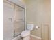Clean bathroom showcasing a tiled shower with sliding glass doors and a toilet with a toilet paper roll next to it at 14047 Briardale Ln, Tampa, FL 33618