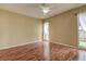 Bedroom features curtains, wood flooring, a ceiling fan, and natural lighting at 14047 Briardale Ln, Tampa, FL 33618