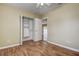 This bedroom has wood flooring, a closet with shelving, and an entry to another room at 14047 Briardale Ln, Tampa, FL 33618