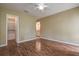 This bedroom features wood flooring, a closet, and an entry to the bathroom at 14047 Briardale Ln, Tampa, FL 33618