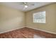 Bedroom featuring wood flooring, a ceiling fan, and a window for natural light at 14047 Briardale Ln, Tampa, FL 33618