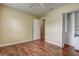 This bedroom features a closet with shelving, an entry to another room, and wood flooring at 14047 Briardale Ln, Tampa, FL 33618