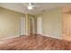 This bedroom features wood flooring, a closet, and an entry to another room at 14047 Briardale Ln, Tampa, FL 33618