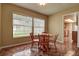 Cozy dining area with a wood table, four chairs, tile floors and natural light from the window at 14047 Briardale Ln, Tampa, FL 33618