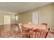Open concept dining and living area with wood-look floors, neutral paint and natural light at 14047 Briardale Ln, Tampa, FL 33618
