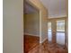 Open hallway with a mix of tile and wood floors leading to a living area with a view of the backyard at 14047 Briardale Ln, Tampa, FL 33618