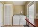Functional laundry room with washer, dryer, ample storage, and convenient exterior access at 14047 Briardale Ln, Tampa, FL 33618