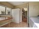 Bright laundry room featuring tile flooring, a large utility sink, ample storage, and access to the kitchen and garage at 14047 Briardale Ln, Tampa, FL 33618