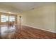 Spacious living room with wood-look floors, neutral walls and a dining area to the left at 14047 Briardale Ln, Tampa, FL 33618