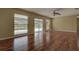 Bright living room with wood-look floors and sliding glass doors to a screened-in patio at 14047 Briardale Ln, Tampa, FL 33618