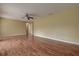 Spacious living room with wood laminate flooring, ceiling fan, neutral wall color, and lots of natural light at 14047 Briardale Ln, Tampa, FL 33618