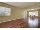 Spacious living room with hardwood floors, natural light, and a dining area with table and chairs at 14047 Briardale Ln, Tampa, FL 33618
