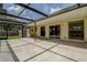 Large screened patio with a concrete floor, access to the backyard, and natural light at 14047 Briardale Ln, Tampa, FL 33618