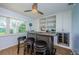 Entertainment wet bar featuring custom wood finishes, wine refrigerator, and built-in shelving for storage at 14534 Yacht Club Blvd, Seminole, FL 33776