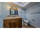 Bathroom with wood vanity, updated fixtures, decorative tile, and a skylight for natural light at 14534 Yacht Club Blvd, Seminole, FL 33776