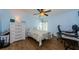 Comfortable bedroom with hardwood floors, a ceiling fan, and a large window allowing for plenty of natural light at 14534 Yacht Club Blvd, Seminole, FL 33776