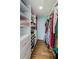 Walk-in closet with custom shelves, drawers, and hanging rods for optimal storage and organization at 14534 Yacht Club Blvd, Seminole, FL 33776