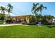 Community clubhouse featuring well-maintained landscaping and manicured lawn at 14534 Yacht Club Blvd, Seminole, FL 33776