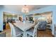 Open concept dining area featuring a contemporary chandelier, and seamless flow into the living and kitchen areas at 14534 Yacht Club Blvd, Seminole, FL 33776