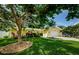Charming yellow home with lush green lawn and mature tree providing shade and curb appeal at 14534 Yacht Club Blvd, Seminole, FL 33776