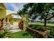Inviting front yard with rocking chairs on the porch, colorful flowers, and a cozy, welcoming atmosphere at 14534 Yacht Club Blvd, Seminole, FL 33776