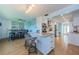 Bright modern kitchen with a marble-top island, stainless steel appliances, breakfast bar, and hardwood flooring at 14534 Yacht Club Blvd, Seminole, FL 33776